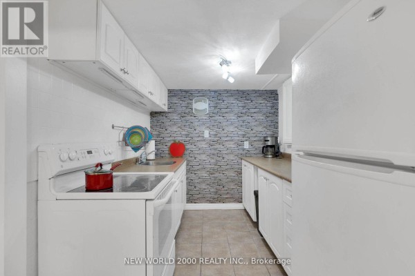 Kitchen with white appliances, white cabinets, and stone-patterned backsplash - 50 Livingstone Street W Barrie