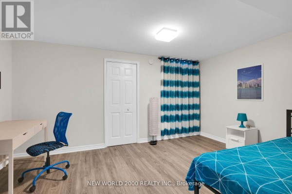 Bedroom with desk, chair, bed, and blue striped curtains - 50 Livingstone Street W Barrie