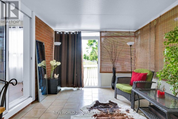 Wicker furniture & cowhide rug in sunroom - 50 Livingstone Street W Barrie