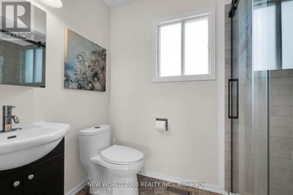 Modern bathroom with vanity, toilet, and glass shower - 50 Livingstone Street W Barrie