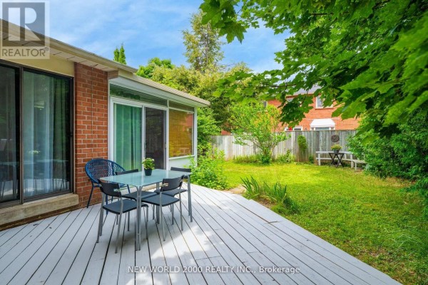 Deck with outdoor dining set overlooking a grassy yard - 50 Livingstone Street W Barrie