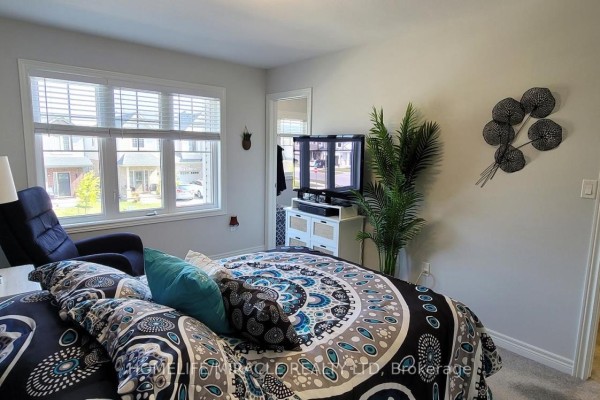 Kitchen area with stainless steel appliances and a living room view. - 50 Lymburner Street, Pelham