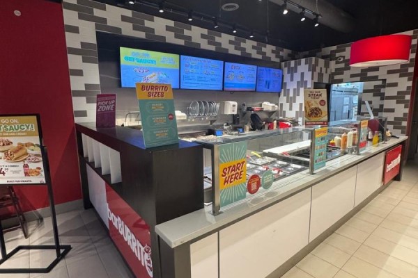 Restaurant counter with digital menu boards, food display cases, and signage for 'burrito sizes'. - 50 Market Street S, Brantford