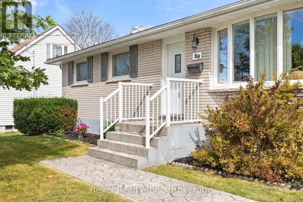 Pathway leading to the front entrance of the house with concrete steps. - 50 St David Street, Kawartha Lakes