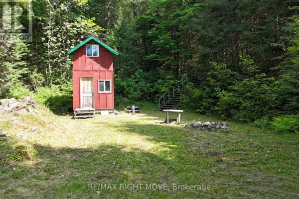 Small red structure with a green roof and stairs on the right side of the property. - 50 Sunrise Drive, Kearney