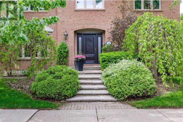 Stone steps leading to the front door, flanked by shrubs and flowers - 500 Blenheim Crescent, Oakville