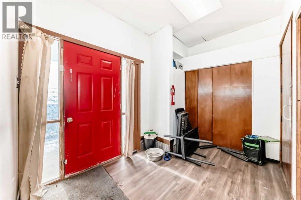 Kitchen featuring wooden cabinets, white appliances, and a window view. - 5001 62 Avenue, Ponoka
