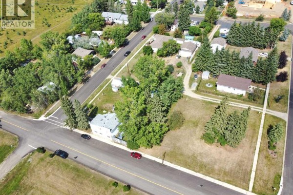 Aerial view of a quiet street lined with houses and trees in Benalto, Alberta. - 5002, 5008, 5010 50 Avenue, Benalto