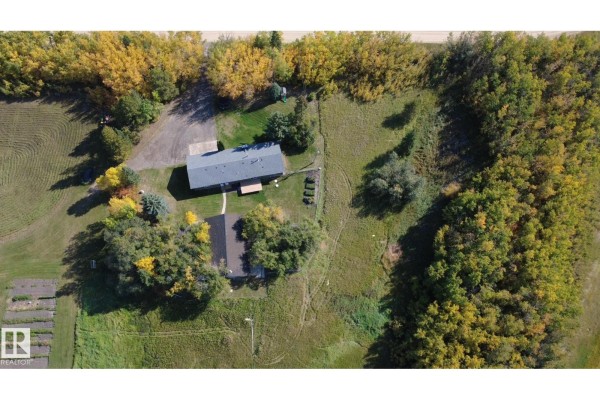 Overhead drone view of the property showing the main house, a detached garage, and surrounding rural landscape. - 50034 Rge Rd 225, Rural Leduc County