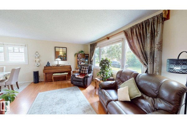 Covered deck area with table and chairs, draped curtains, and gazebo roof. - 5004 50 Av, Evansburg