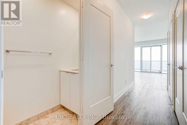 Interior hallway with doors, a small vanity area, and a view of a balcony. - 5005 - 70 Annie Craig Drive, Toronto
