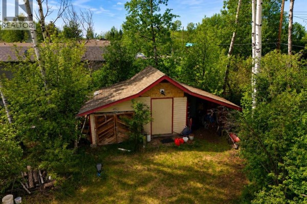 Back deck of the house, partially covered in snow, with a clothesline visible. - 5008 Tardiff Avenue, Fort Vermilion