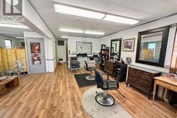 Hair salon with wood floors, chairs, mirrors, and a reception area. - 5009 50, Valleyview