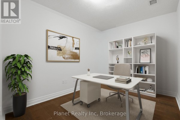 Home office with desk, chair, and a white bookshelf against the wall. - 501 - 150 Wellington Street E, Guelph