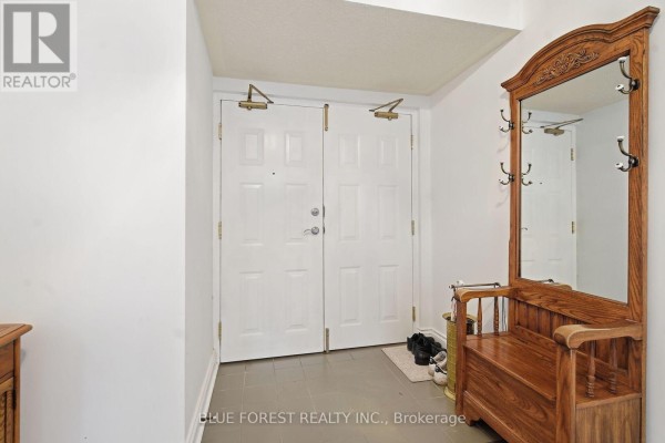 Foyer with white doors, a wooden bench, and coat hooks. - 501 - 7 Picton Street, London East