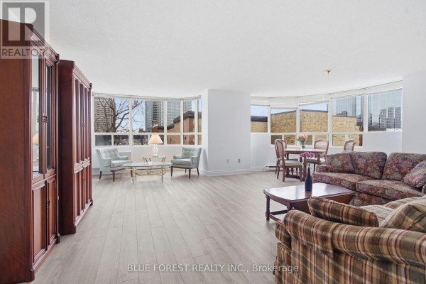 Long hallway with wooden flooring, a mirror, and natural light from windows. - 501 - 7 Picton Street, London East