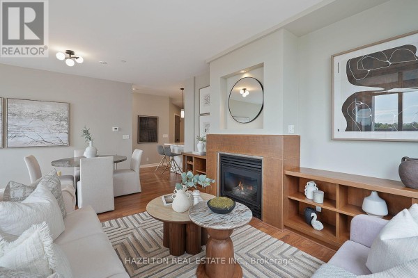 Living room fireplace with wooden surround, built-in shelving, and contemporary decor. - 501 - 980 Yonge Street, Toronto