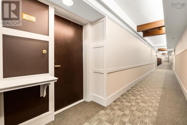 Hallway of an apartment building with a suite door labeled 501 and patterned carpet. - 501 1479 Lower Water Street, Halifax