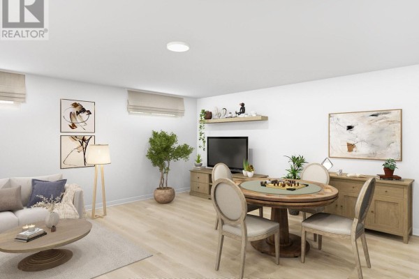 Living and dining area with light wood floors, a round dining table and sectional sofa. - 501-515 Stompin' Tom Private, Ottawa