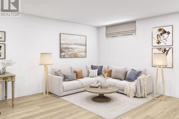 Living area with beige sectional sofa, round coffee table, and two floor lamps. - 501-515 Stompin' Tom Private, Ottawa