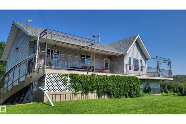 Front view of a detached garage with two bays, one closed and one open. - 50128 Hwy 22, Rural Brazeau County