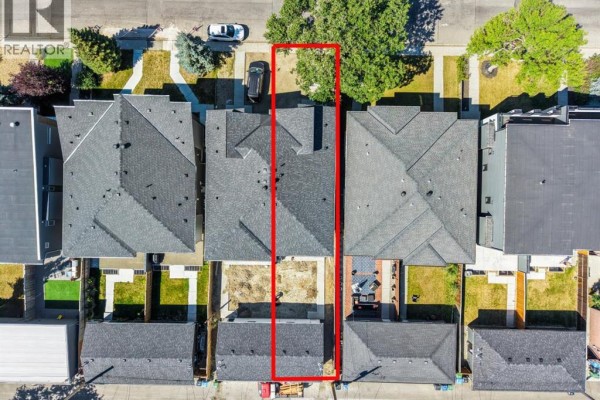 Aerial view showing a duplex home with a red outline marking the property boundaries. - 5014 22 Street, Calgary