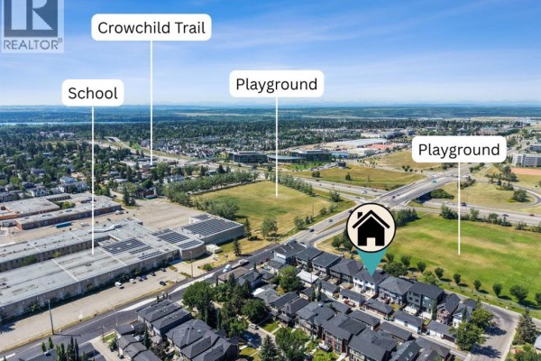 Aerial view showing the duplex property with Crowchild Trail and schools nearby. - 5014 22 Street, Calgary