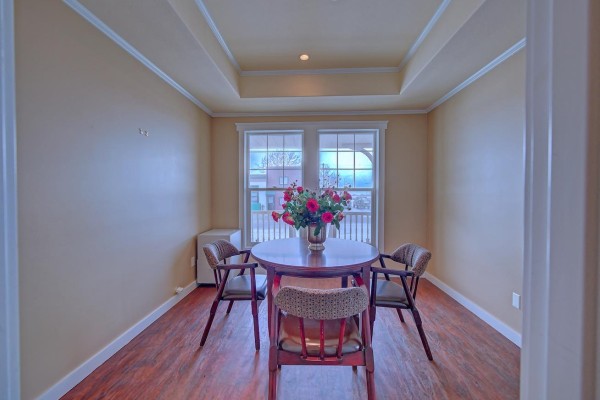 Spacious room with dining area, large windows, and development concept display. - 5015-50 Street, Chipman