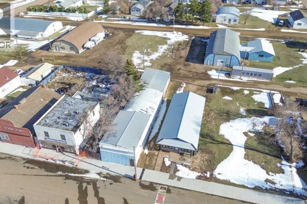 Aerial view showing multiple commercial buildings and outbuildings on a street in Donalda. - 5015 Main Street, Donalda