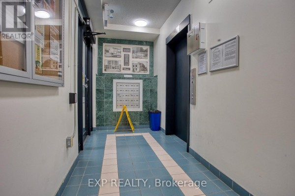 Elevator lobby with green marble accents, mailboxes, and blue tiled floor. - 502 - 17 King Street E, Hamilton