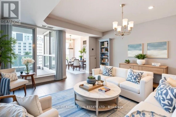 Living room with a sectional sofa, coffee table, and balcony access overlooking the city. - 502 - 218 Queens Quay W, Toronto