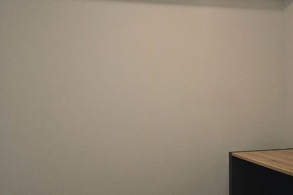 Corner of a room showing a light wood surface on a dark cabinet against a plain wall. - 502 - 8 Trent Avenue, Toronto