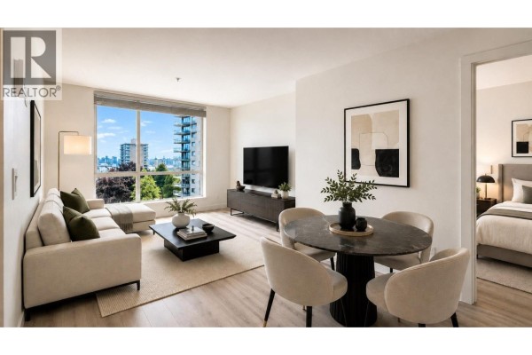 Living and dining area with beige sofa, oval table, and city view. - 502 128 E 8th Street, North Vancouver