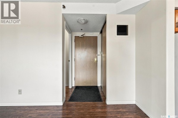 Hallway entrance to apartment with wood door and closet. - 502 430 5th Avenue N, Saskatoon