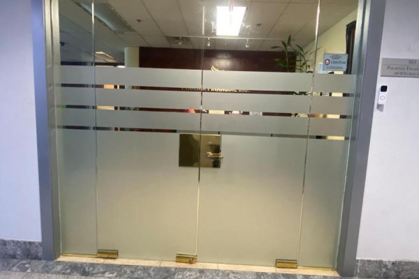 Frosted glass double doors with "Phoenix Financial Inc." text and brass hardware. - 503 - 3601 Highway 7 E, Markham
