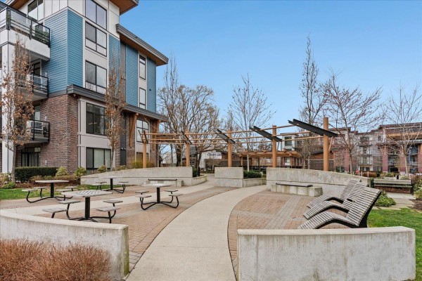 Exterior view of the building surrounded by trees and landscaped area - 503 45500 Market Way, Garrison Crossing, Chilliwack