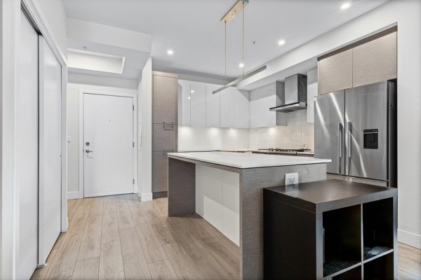 Entrance of the building featuring glass doors and brick facade - 503 45500 Market Way, Garrison Crossing, Chilliwack