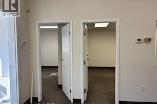 Two office doors leading to separate rooms with carpeted flooring. - 5035 North Service Road Unit# C-13, Burlington