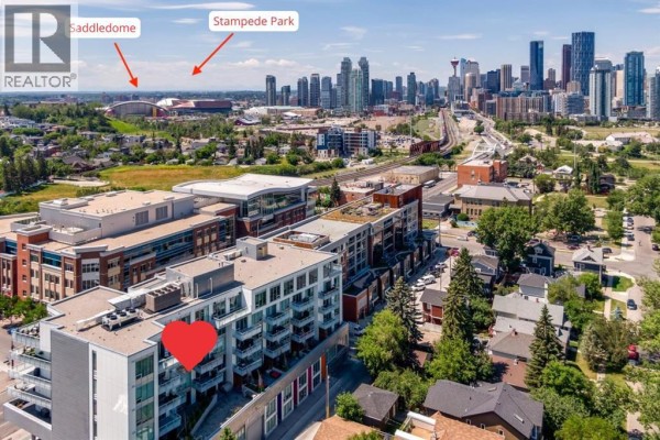 Aerial view of Calgary skyline with Stampede Park and Saddledome in the distance, overlooking apartment buildings. - 504, 1020 9 Avenue Se, Calgary