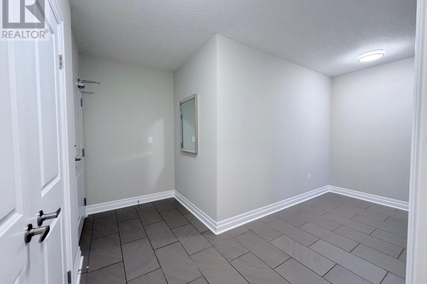 Bathroom with a grey vanity, granite countertop, toilet, and a glass-enclosed shower. - 504 - 240 Villagewalk Boulevard, London North