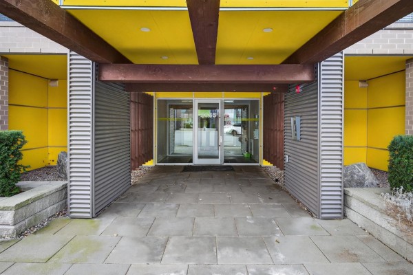 Entrance of the building featuring a covered walkway and glass doors - 504 2555 Ware Street, Abbotsford