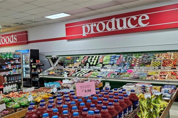 Produce section of a grocery store with fruits, vegetables, and bottled drinks. - 504 Front Street, Wolseley