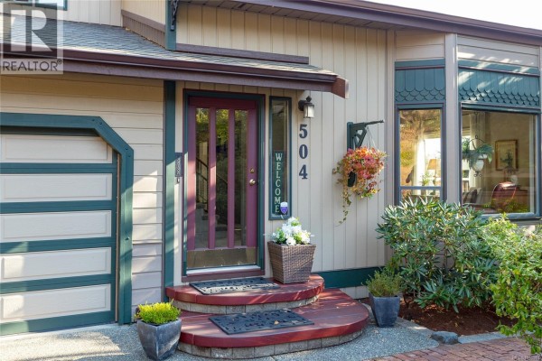 Close-up of the front entrance with a burgundy door, glass panels, and address number 504. - 504 Langvista Dr, Langford