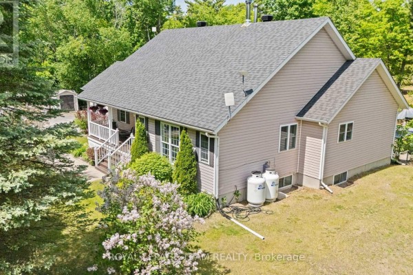 Aerial view of the backyard with an oval swimming pool and wooden deck. - 5040 Stonecrest Road, Ottawa