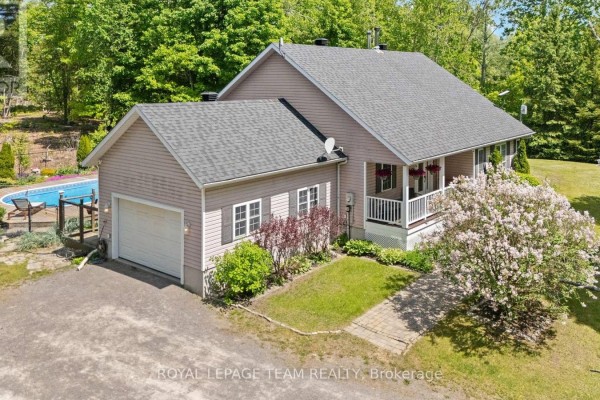 Bedroom with light grey walls, hardwood floors, and a glass door leading outside. - 5040 Stonecrest Road, Ottawa