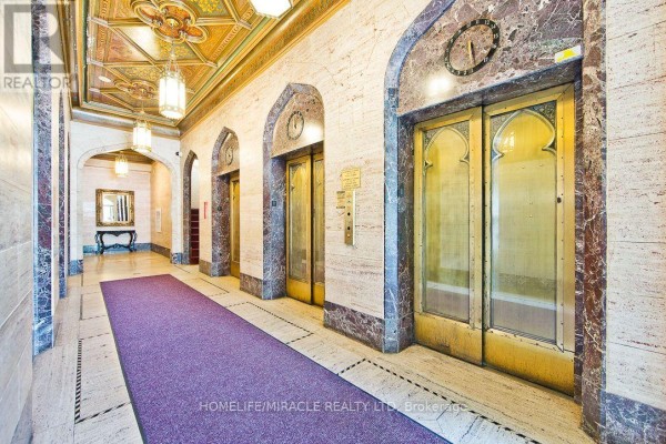 Elevator lobby with ornate golden doors and marble accents. - 505 - 36 James Street S, Hamilton