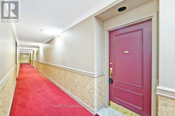 Apartment building hallway with red carpet and burgundy doors. - 505 - 36 James Street S, Hamilton