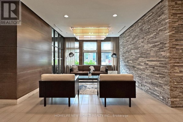 Lobby seating area with stone accent wall, wood paneling, and modern lamps. - 506 - 1 Hurontario Street, Mississauga