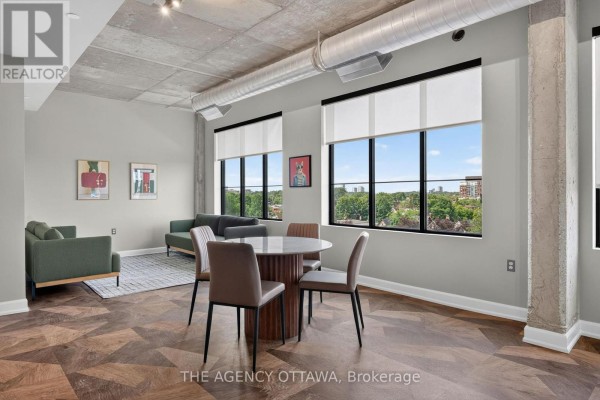 View of kitchen and dining area in an apartment with light wood-look flooring. - 506 - 56 Bayswater Avenue, Ottawa