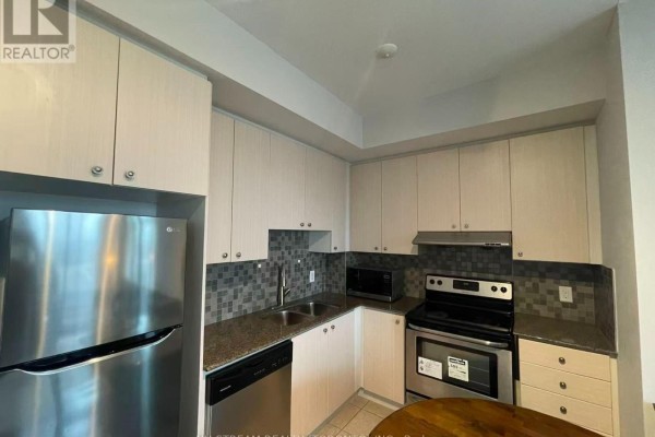 Compact kitchen with light wood cabinets, granite countertops, stainless steel appliances, and tile backsplash. - 506 - 8323 Kennedy Road, Markham